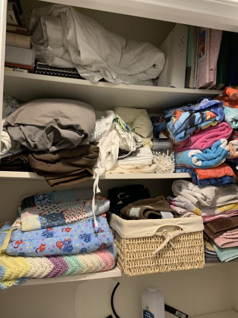 Linen closet makeover before